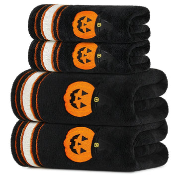 Four black Halloween towels with orange pumpkin motifs and striped borders