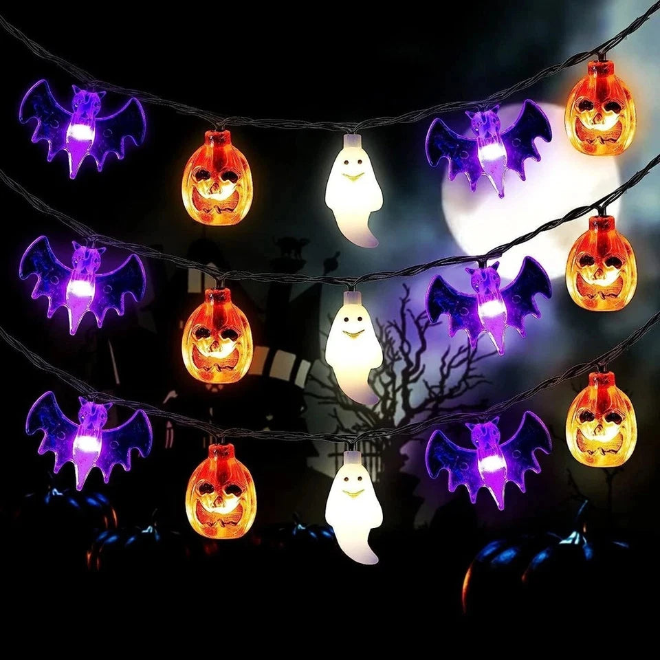 Glowing pumpkin, bat, and ghost lights against a dark Halloween backdrop