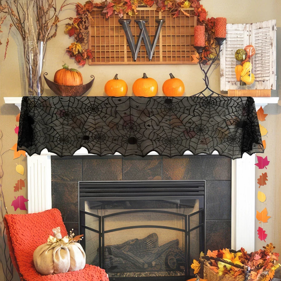 Black lace runner draped across a mantel decorated with pumpkins