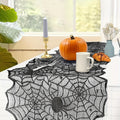 Spiderweb lace table runner styled with a pumpkin, mug, and vase