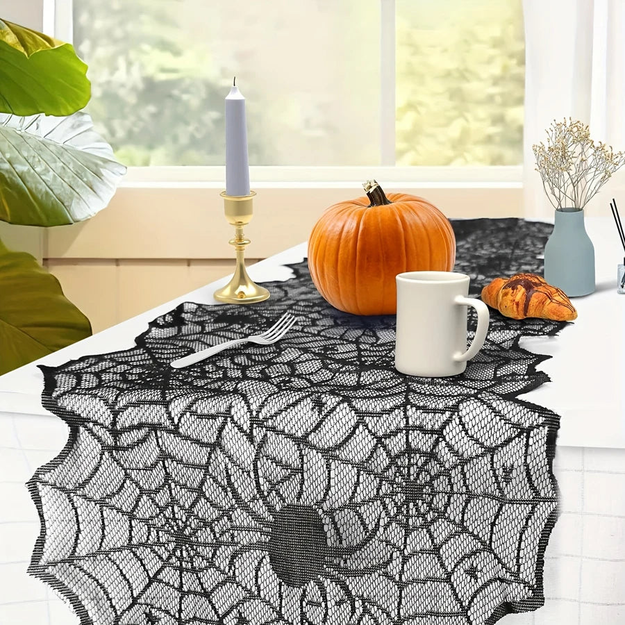 Spiderweb lace table runner styled with a pumpkin, mug, and vase
